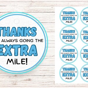 May include: Eight blue and white round gift tags with the text "Thanks for always going the extra mile!" printed on them.