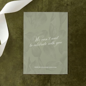 May include: A rectangular sage green card featuring a subtle, tonal botanical illustration of leaves and flowers. The text "We can't wait to celebrate with you" is printed in white script, with the website "WWW.ELLENANDJULIAN.COM" below it.
