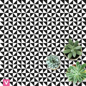 May include: A surface covered in a black and white geometric pattern of triangles. Three potted succulents in shades of green are arranged on the surface. The pattern is a repeating design of black and white triangles.