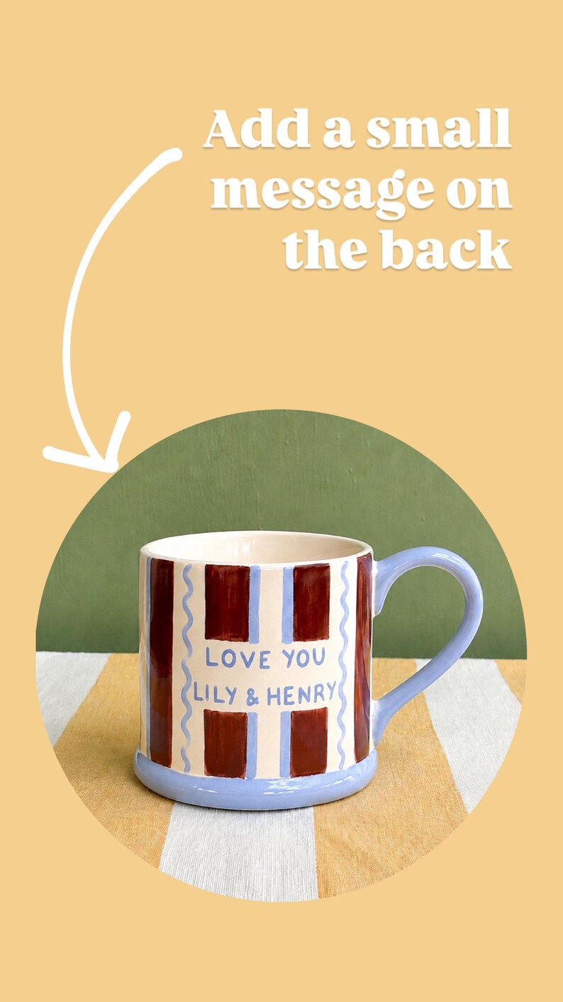 May include: A ceramic mug with a blue handle and base, featuring a design of alternating maroon and white vertical stripes. The mug has the text "LOVE YOU LILY & HENRY" in blue.