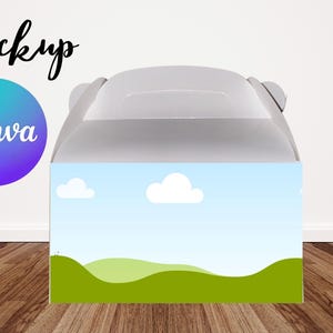 May include: A white gift box with a handle, featuring a sky and landscape design. The box has a blue sky with white clouds and green rolling hills. The word "Mockup" is written in black script.