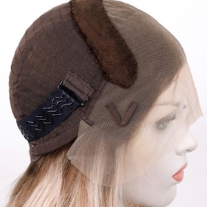 May include: A light brown wig with a lace front and adjustable straps. The wig is made of human hair and has a natural look.