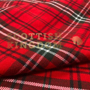 May include: Close-up of red plaid fabric with black and white stripes. The fabric has a woven texture and a diagonal pattern. The text "SCOTTISH KINGDOM" is visible in the image.