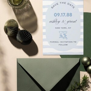 May include: A blue and white striped save the date card with the text "Save the Date" in a circle. The date "09.17.88" is written in a circle below the text. The names "ashley & grant" are written below the date. The text "New York, NY" is written below the names. Two champagne glasses are drawn below the text. The text "Formal Invitation to Follow" is written below the glasses.