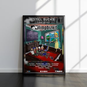 May include: A framed poster featuring the album art for "Still Sucks" by Limp Bizkit. The artwork depicts a cartoon scene with a woman vacuuming a rug where a group of people are sitting. The poster includes the band's logo and a tracklist.