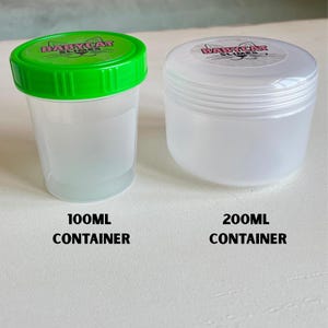 May include: Two translucent plastic containers with lids. The container on the left has a green lid and the text "BABYCAT SLIMES". The text "100ml CONTAINER" is below it. The container on the right has a white lid and the text "200ml CONTAINER" below it.