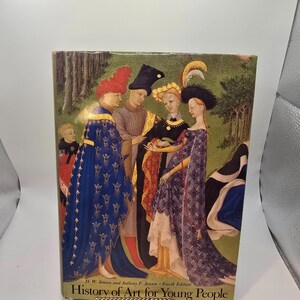 May include: A hardcover book titled "History of Art for Young People" featuring a Renaissance-style painting on the cover. The artwork depicts several figures in elaborate clothing, with a forest backdrop. The book's cover is a mix of colors, including blue, red, and gold.