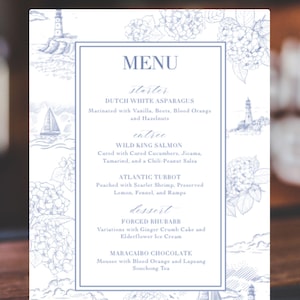 May include: A white menu with blue illustrations of lighthouses, sailboats, and flowers. The menu lists a starter, entree, and dessert with descriptions of each dish. The menu is titled "MENU".