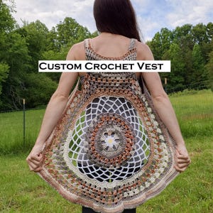 May include: A custom crochet vest in shades of brown, beige, and white. The open-weave design features a circular pattern with a floral center. The text "CUSTOM CROCHET VEST" is displayed across the top of the image.