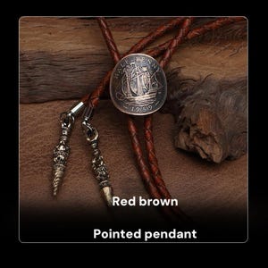 May include: A bolo tie featuring a silver coin with a ship design, dated 1959, at the center. The tie has a red-brown leather cord and decorative, pointed metal tips. The text "Red brown" and "Pointed pendant" are visible.