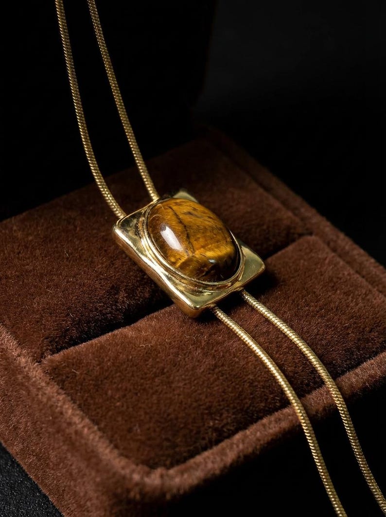 Close view of adjustable chain mechanism allowing the necklace to be styled shorter or longer as a bolo tie.