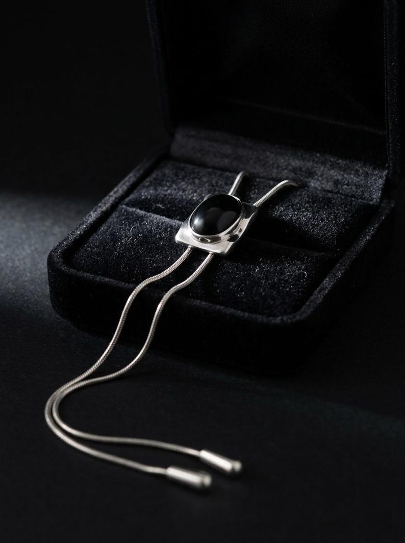 Detail shot of adjustable slider mechanism on a women’s bolo tie necklace, showing flexible Y chain styling and smooth silver finish, designed for comfortable daily wear.