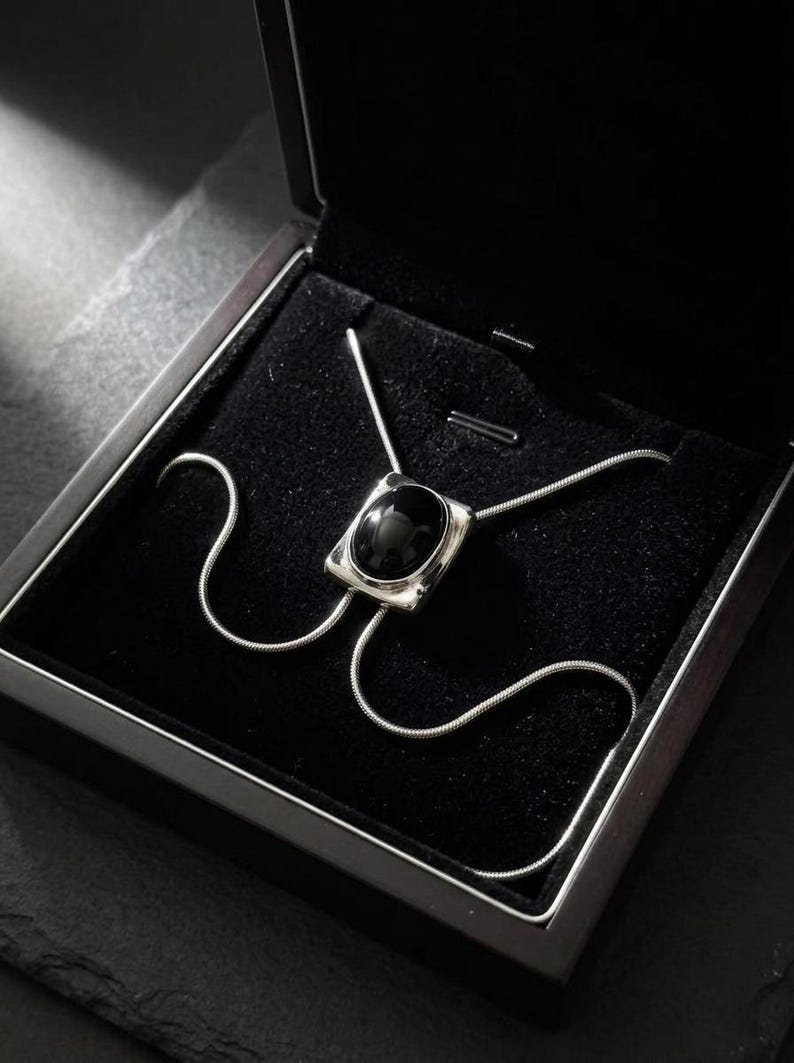 Gift-ready packaging presentation with silver bolo tie necklace and black onyx, styled as a premium jewelry gift for women, perfect for birthdays or special occasions.
