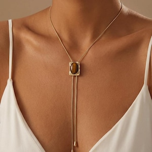 Western cowgirl bolo necklace worn with a dark dress shirt highlighting the refined old money aesthetic.
