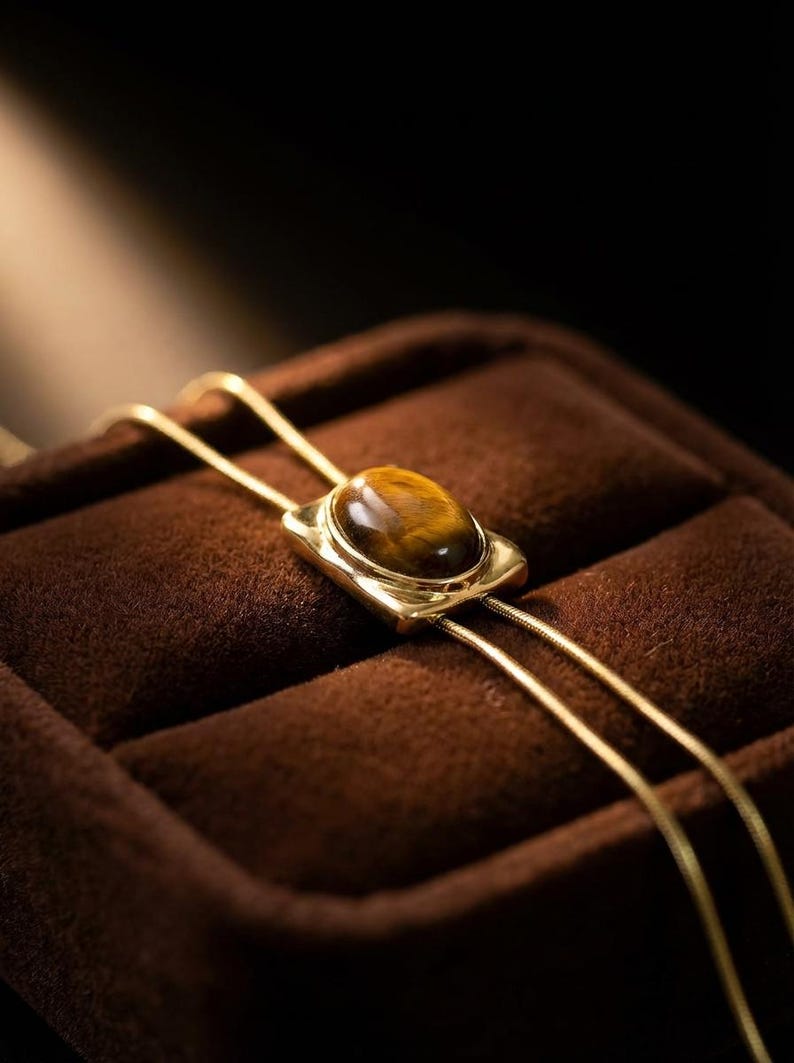 Natural tiger eye gemstone necklace reflecting warm golden brown tones that complement western fashion aesthetics.