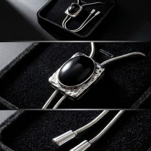 Close-up of black onyx pendant set in a silver-tone frame, showing smooth polished surface and reflective shine, paired with a delicate adjustable chain in a bolo tie Y necklace style for women.