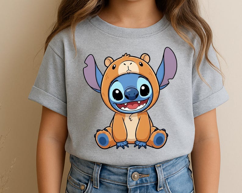 A person wearing a gray t-shirt with a cartoon character printed on it.