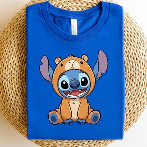 A blue t-shirt with a cartoon character wearing a bear costume.
