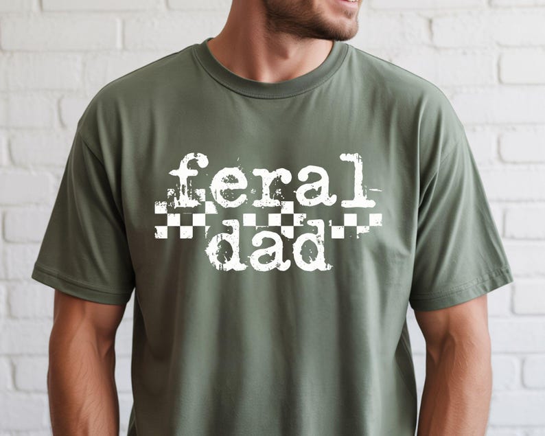 A man wearing a green t-shirt with the text "feral dad" printed on it.