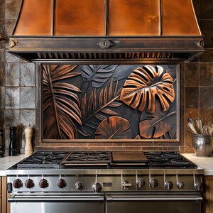 May include: A stainless steel gas stove with a black cast iron grate and a copper backsplash featuring a tropical leaf design.