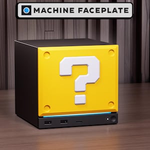 May include: A black cube-shaped machine faceplate featuring a bright yellow front panel with a large white question mark symbol. The front panel includes four circular indentations at the corners and a thin blue light strip above the black base.