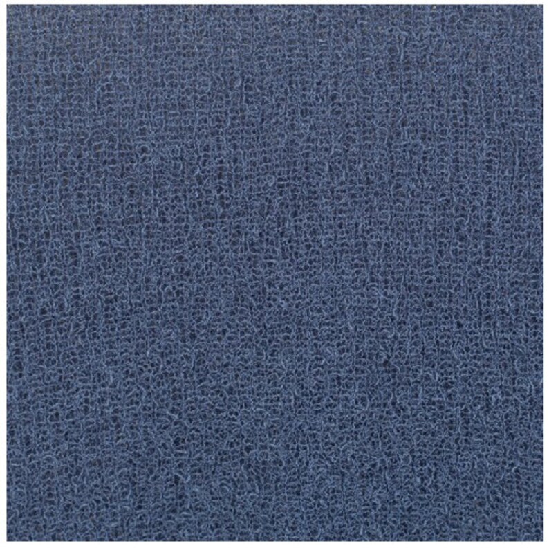 May include: A close-up of a blue textured fabric with a woven pattern.