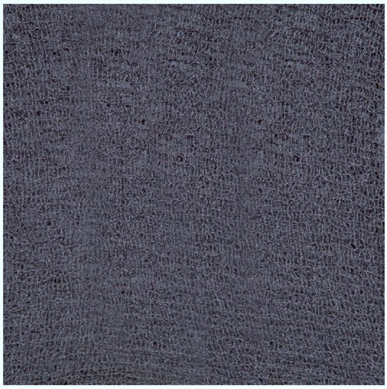 May include: A close-up of a dark blue textured fabric with a fine, almost cracked, pattern.