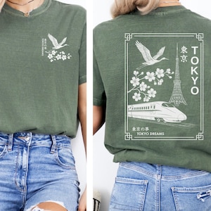 Moss comfort colors shirt with Tokyo Japan aesthetic design on the back, including Tokyo-inspired imagery like the crane bird, sakura or cherry blossoms, Tokyo Tower and kanji for Tokyo.