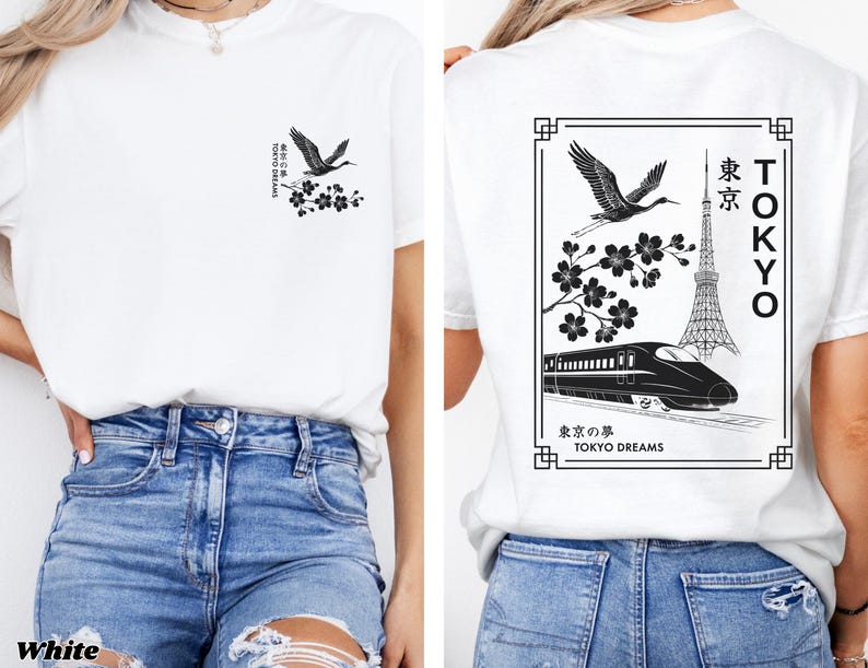 May include: White t-shirt with a black and white graphic print of a crane, cherry blossoms, and a train in front of the Tokyo Tower. The text "TOKYO" is written vertically on the right side of the graphic. The text "東京の夢 TOKYO DREAMS" is written below the graphic.