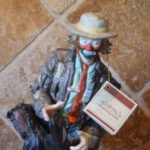 May include: A white ceramic mug with a black handle and the text "But First, Coffee" in a handwritten style. The mug is on a white surface. The mug is likely for hot beverages.