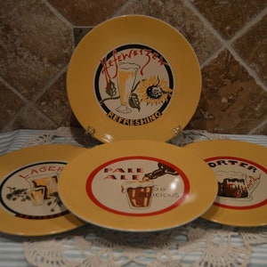 May include: Four yellow ceramic plates with red and black borders. Each plate features a different beer style: "Lager", "Pale Ale", "Porter", and "Hefeweizen". The plates are decorated with illustrations of beer glasses and text.