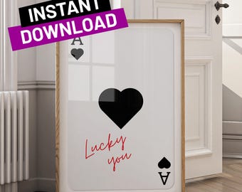 May include: A white poster with a black heart and the text "Lucky you" in red. The poster also features a black ace of spades card with the ace and spade symbols.