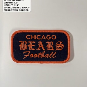 May include: A rectangular embroidered patch with a merrowed orange border and a dark navy blue background. The text reads CHICAGO BEARS Football in orange embroidery. The patch measures 3.8 inches in width and 2.3 inches in height.