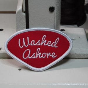 May include: A rustic wooden sign with the text "Welcome" in a handwritten style. The sign is painted white with a distressed finish, and features a decorative floral element. The sign measures approximately 12 inches wide.