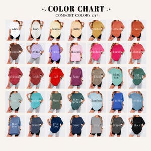 May include: A color chart displays a variety of Comfort Colors 1717 t-shirts in various colors, including white, ivory, and black. The chart includes the names of the colors, such as "Espresso," "Orchid," and "Blue Jean."