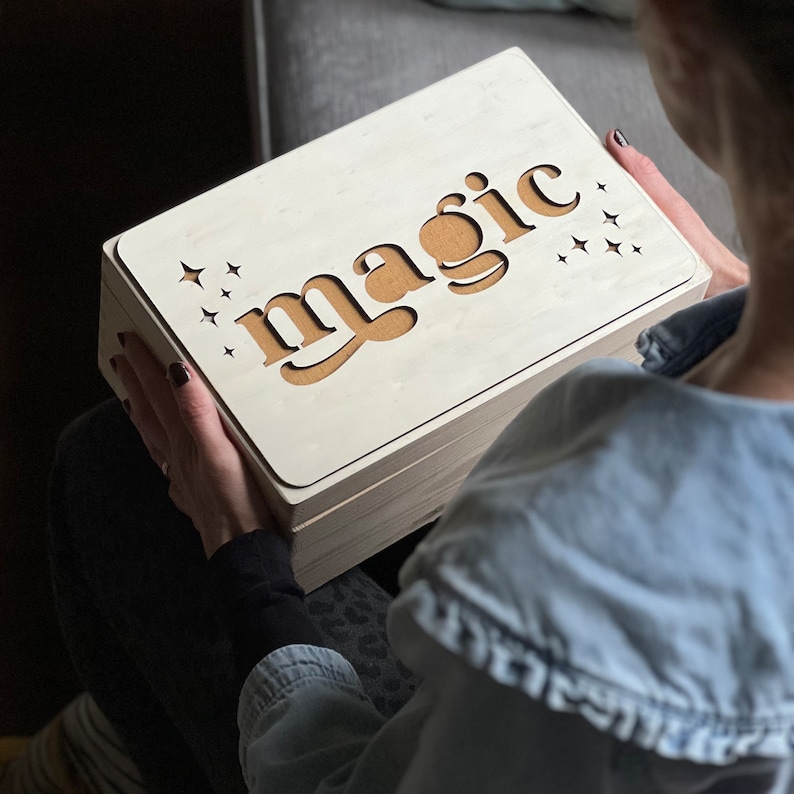 Christmas Eve box by modo. Mustard fabric with wooden overlay on the word magic