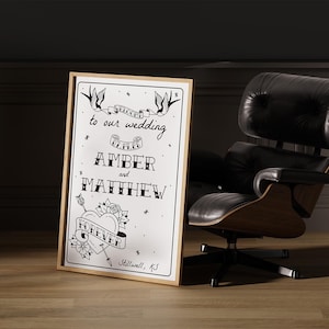 May include: A black and white wedding sign with a heart, arrows, and birds. The sign reads "Welcome to our wedding Amber and Matthew Forever Stillwell, KS".