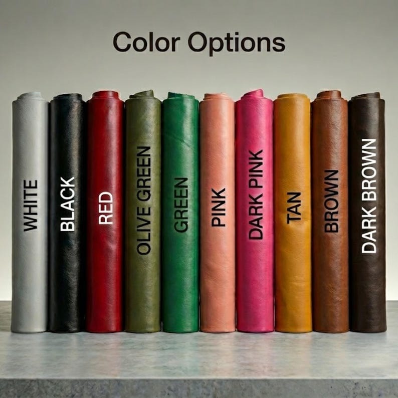 May include: A selection of rolled leather in a range of colours: white, black, red, olive green, green, pink, dark pink, tan, brown, and dark brown. The text "Color Options" is at the top, with each colour labelled vertically.