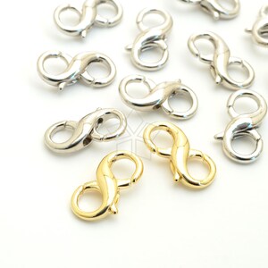 May include: A collection of silver and gold lobster clasps, also known as trigger clasps, for jewelry making. The clasps are in the shape of an infinity symbol.
