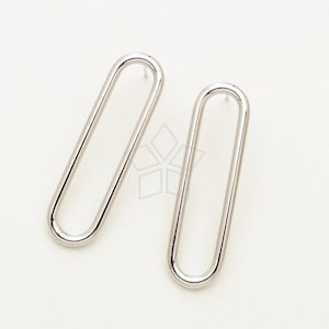 May include: A pair of silver oval-shaped earrings. The earrings are simple and modern in design.