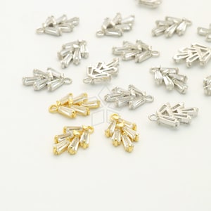 May include: A collection of gold and silver tone metal charms featuring a cluster of baguette-shaped crystals. The charms have a loop at the top for attaching to jewelry.