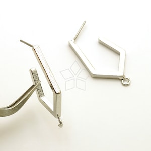 May include: Two silver earring hoops with a geometric shape. The hoops have a small loop at the bottom for attaching charms or other jewelry.