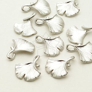 May include: A set of ten silver-toned ginkgo leaf charms with a loop for attaching to jewellery or other crafts.