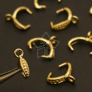May include: Gold-toned metal clasps with a textured design. The clasps are designed to be used for jewelry making.