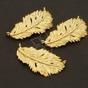 May include: Three gold-colored metal feather charms with a textured surface. Each charm has a loop at the top for attaching to jewelry or other crafts.