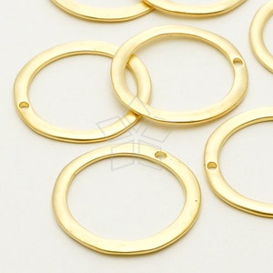 May include: Gold-toned metal jump rings with a hammered finish. The rings are approximately 2.5 cm in diameter and have a single hole for attaching jewellery components.