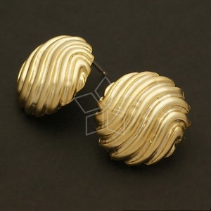 May include: A pair of gold-toned earrings with a textured, wavy design. The earrings are round and have a smooth, polished finish.