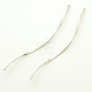 May include: Two silver, twisted, wire headbands. The headbands are curved and have a smooth, shiny finish.