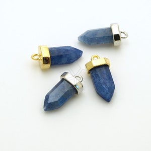 May include: Four blue gemstone pendants with gold and silver accents. The gemstones are in the shape of a point and have a rough, natural texture.