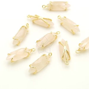 May include: Ten rose quartz crystal pendants with gold wire wrapped around them. Each pendant has a gold jump ring for attaching to a chain or cord.